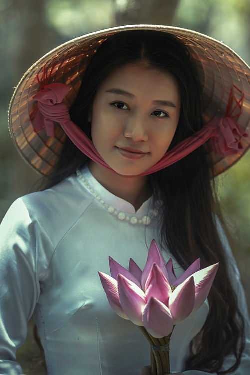 Stock Photo Vietnamese girl wearing a bamboo leaf hat