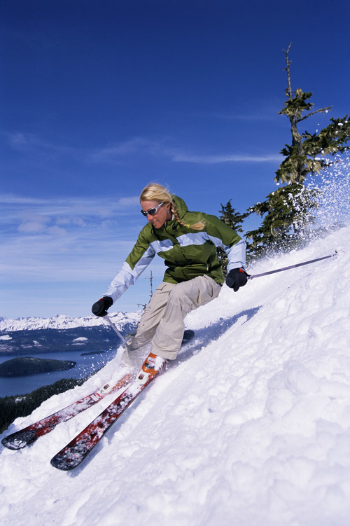 Stock Photo Woman alpine skiing