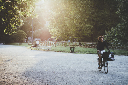 Stock Photo Woman riding a bicycle in the morning