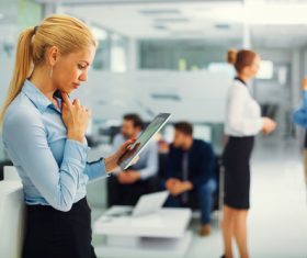Stock Photo Woman using tablet in company
