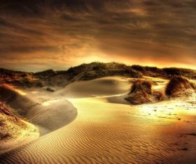 The afterglow of the sunset shines on the sand dunes Stock Photo