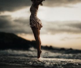 Woman jumping on the beach Stock Photo