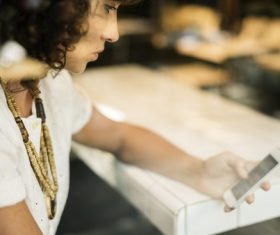 Woman looking at mobile phone in cafe Stock Photo