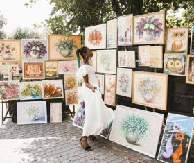 Black beautiful girl looking at art exhibition Stock Photo