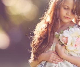 Cute little girl holding bouquet Stock Photo