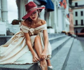 Elegant woman tying shoelaces Stock Photo