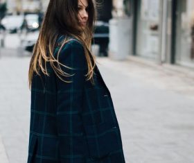 Long-haired woman with bag on the street Stock Photo