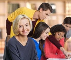 Male and female students in school classroom Stock Photo