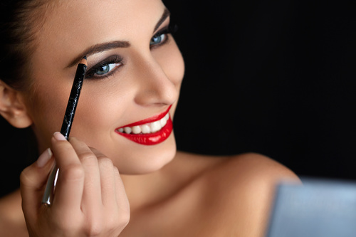 Paint the brows woman Stock Photo