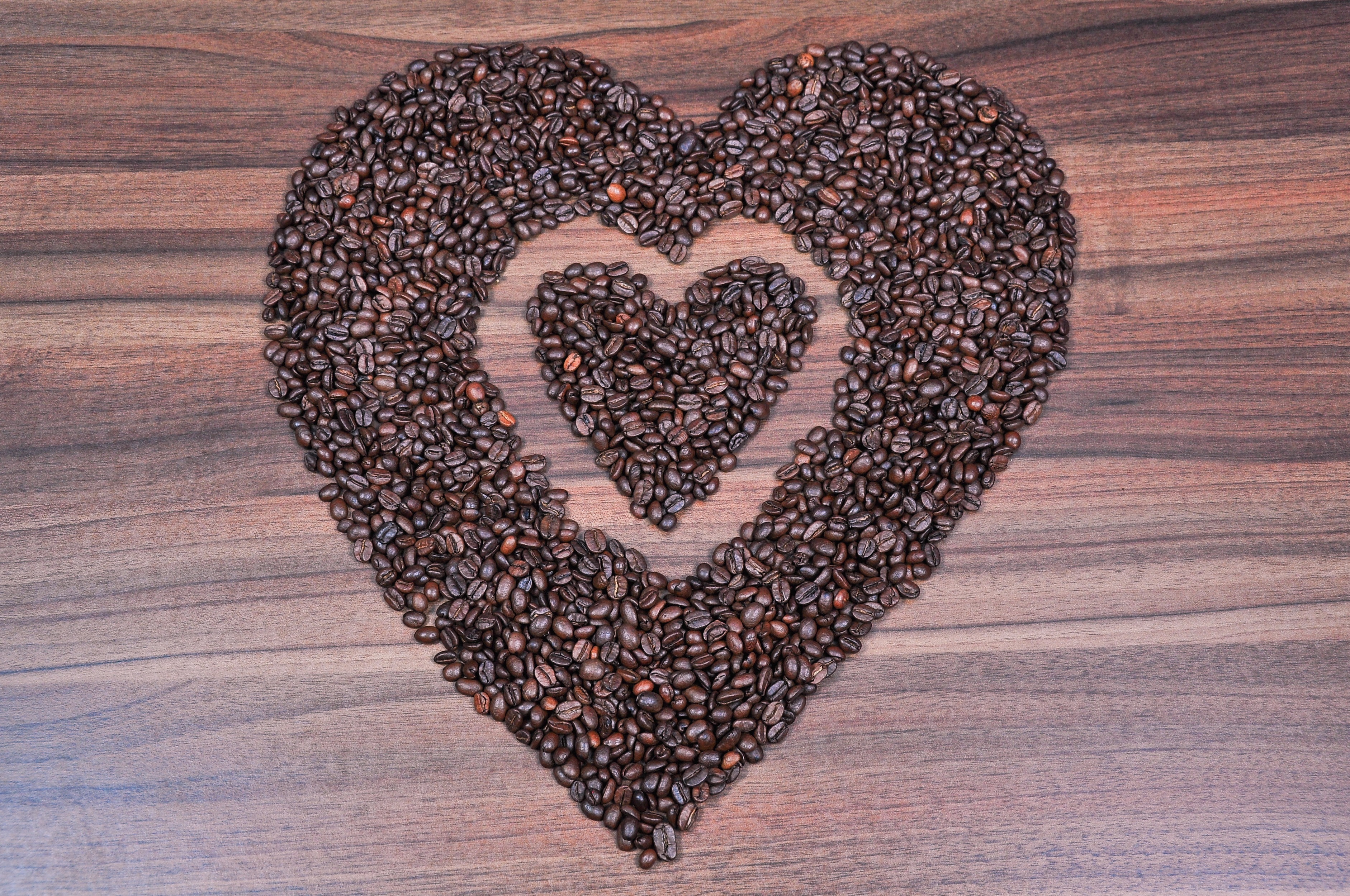 Placing coffee beans heart-shaped pattern Stock Photo