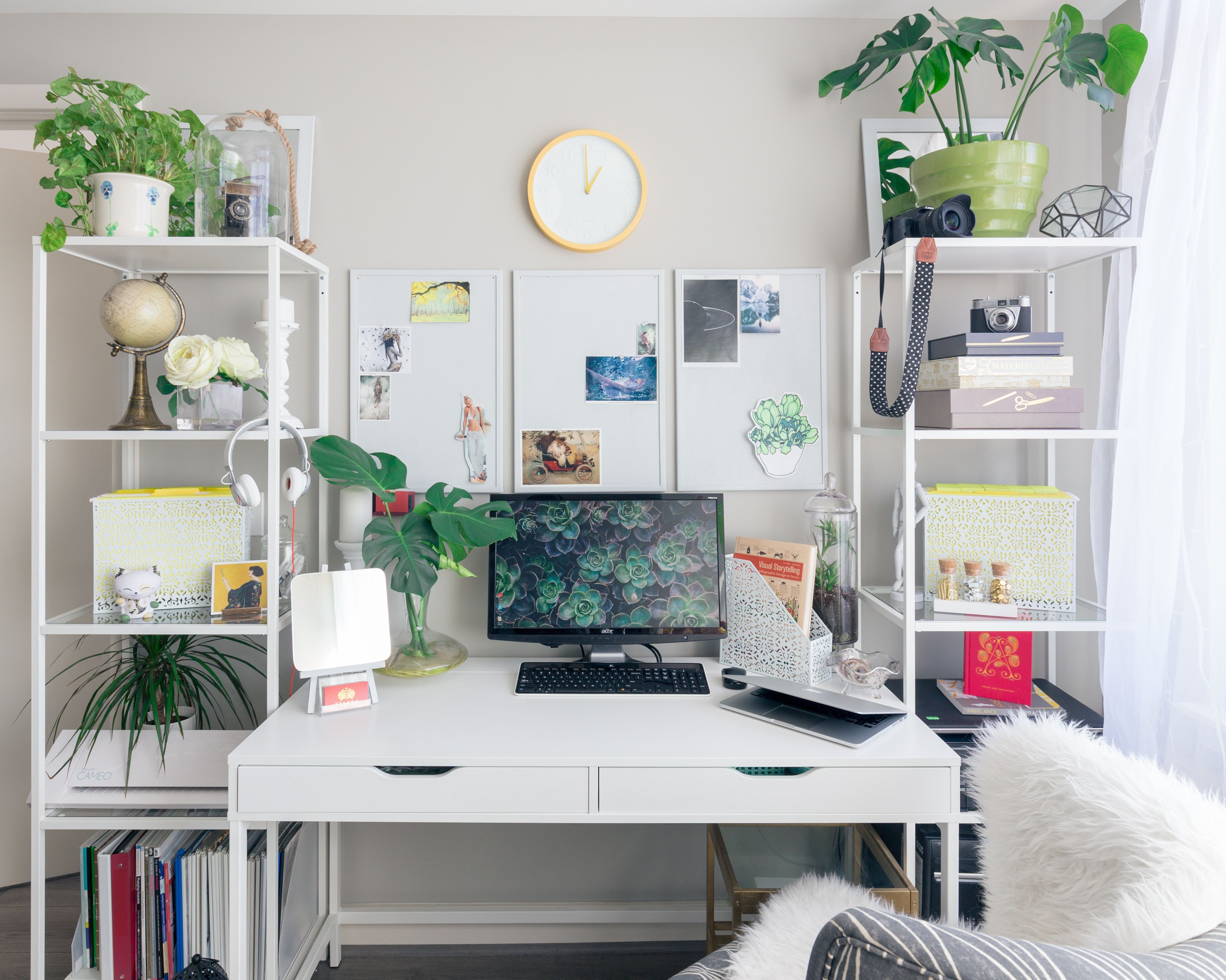 Plants and computers on desk shelves Stock Photo