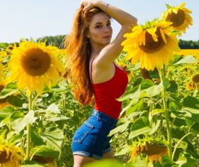 Stock Photo Woman posing in sunflower field