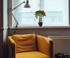 Stock Photo Yellow sofa placed by the window