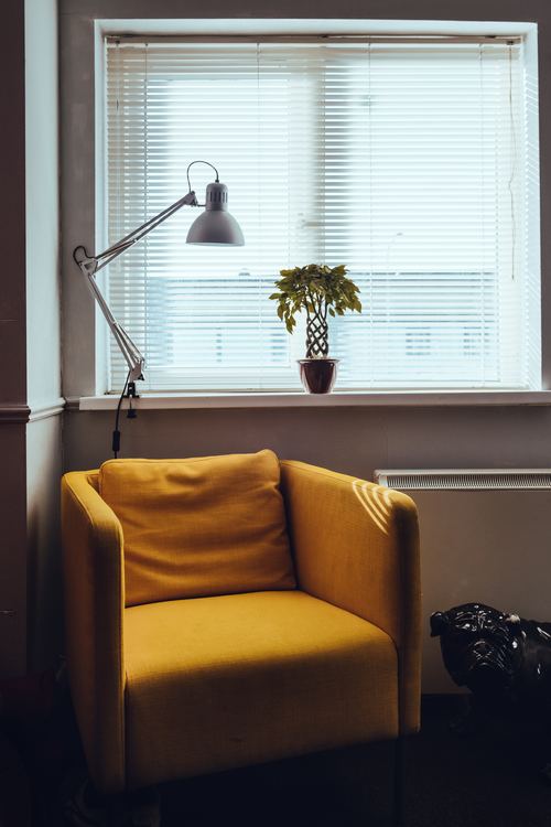 Stock Photo Yellow sofa placed by the window