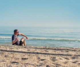 Taking pictures of people standing on the beach Stock Photo 05