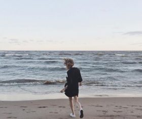 Taking pictures of people standing on the beach Stock Photo 08