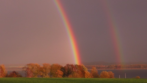 Two rainbows on the horizon Stock Photo