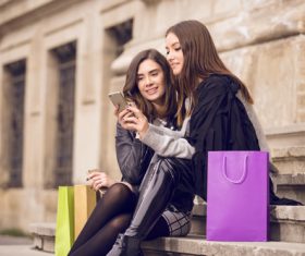 Two shopping beauty sitting on the steps Stock Photo