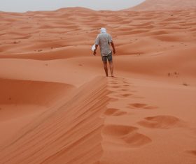 Walking alone in the desert Stock Photo