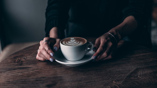 Woman drinking latte Stock Photo