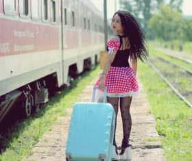 Woman pulling suitcase to travel Stock Photo
