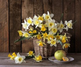 Apple with yellow and white flowers in basket Stock Photo