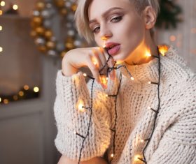 Beautiful girl around the Christmas lights Stock Photo