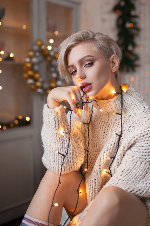 Beautiful girl around the Christmas lights Stock Photo