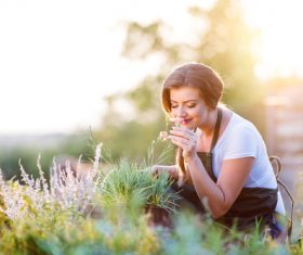Beautiful woman smelling flowers Stock Photo