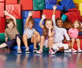 Children raising their hands to answer questions Stock Photo