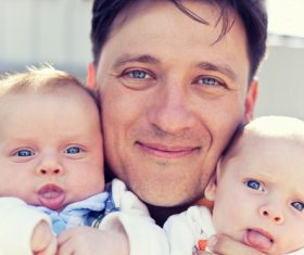 Dad holding twin brothers Stock Photo