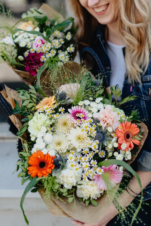 Girl carrying a basket full of flowers Stock Photo 01