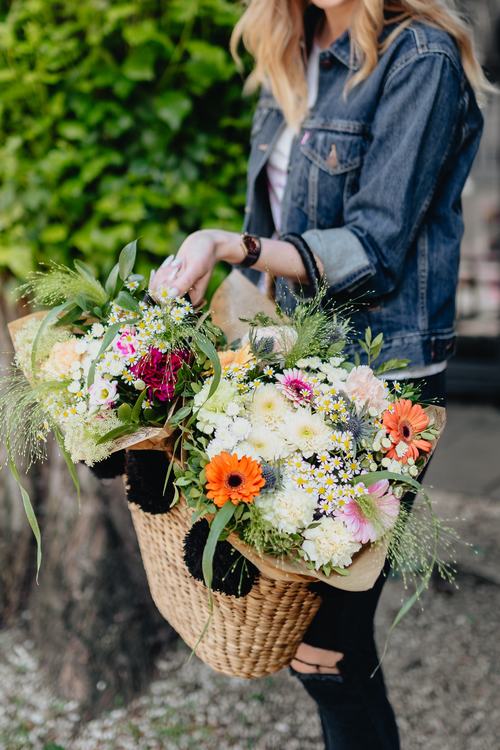 Girl carrying a basket full of flowers Stock Photo 03
