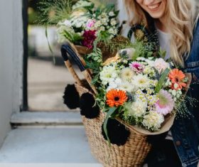 Girl carrying a basket full of flowers Stock Photo 05