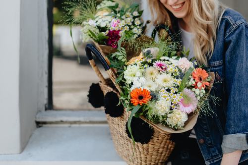 Girl carrying a basket full of flowers Stock Photo 05