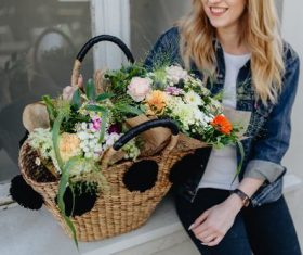 Girl carrying a basket full of flowers Stock Photo 06