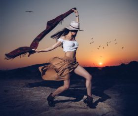 Girl dancing in the sunset Stock Photo