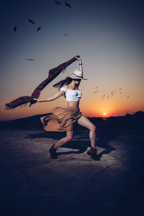 Girl dancing in the sunset Stock Photo