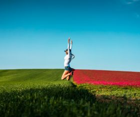 Happy Woman Jumping in the Air Stock Photo