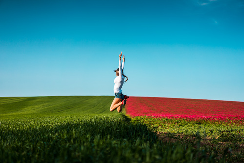 Happy Woman Jumping in the Air Stock Photo