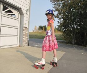 Little girl rollerblading Stock Photo