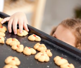 Little girl takes freshly baked cookies Stock Photo 01