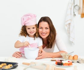 Mother and daughter making cookies together Stock Photo 02