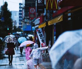 People with umbrellas on the rainy streets Stock Photo 05