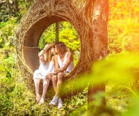 Romantic lovers on swing Stock Photo