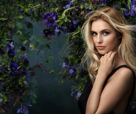 Smiling beautiful woman with different flowers background Stock Photo 02