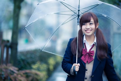 Smiling girl hold up an umbrella Stock Photo