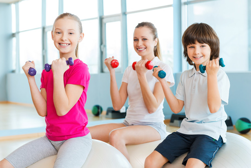 Stock Photo Happy child photography holding a dumbbell