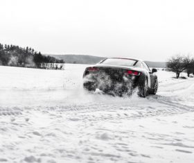 Supercar Drifting on a Snow Covered Road Stock Photo