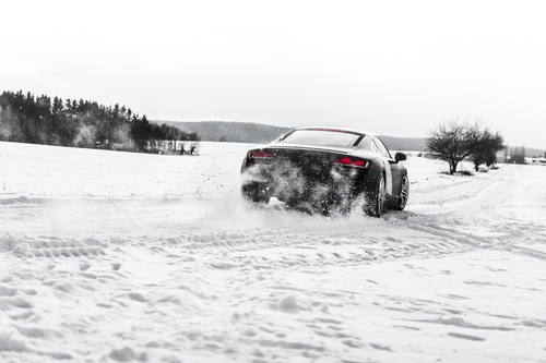 Supercar Drifting on a Snow Covered Road Stock Photo
